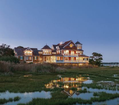 Grand yet graceful, this home looks right for the site thanks to recessed balconies, varied roof lines, and  crisp window detailing.    