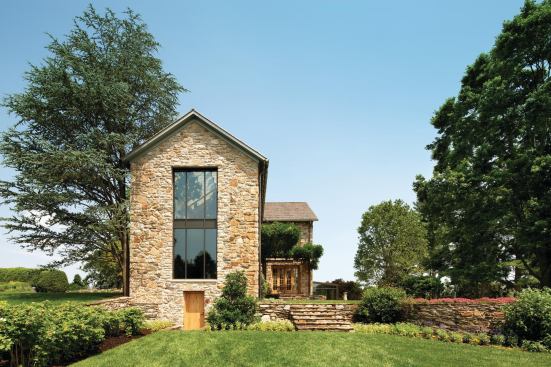 The north-facing wing's first-floor library and second-floor master bath focus views across the gardens to the dairy barn and farm animals. The stone steps are on axis with the living room opening; beyond is the orangery.