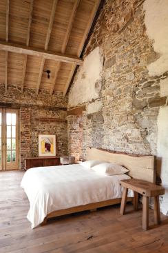 Seventeeth-century French oak floors, some original to the house, were planed down and given a velvety finish rather than a hard sheen. The master bedroom's walls re-create the existing house's old wood lintels and white parge coating.