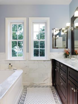 Marble tiles line the home's renovated bath.