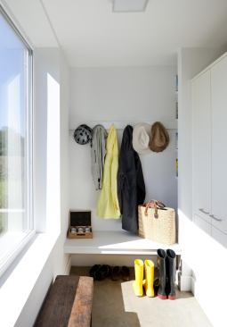 The small mud room with a built-in bench helps the family stay organized and keeps the house free of clutter.