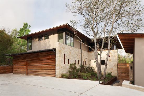 The house is clad in Lueders limestone from west Texas. Garage and fencing are made of durable, sustainably harvested garapa.