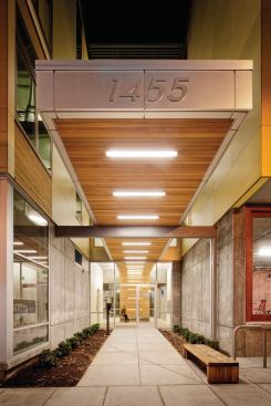 The 57-unit condo building features a welcoming canopy and landscaped lobby entrance.