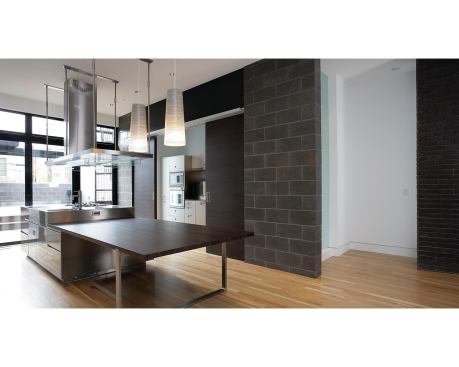 Studio Dwell brought the home's dark exterior color palette inside, lending a sense of continuity to the entire project.