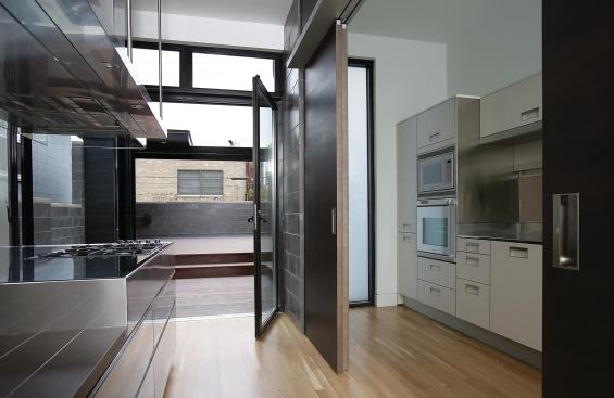 The home's kitchen opens directly onto a private rear terrace.