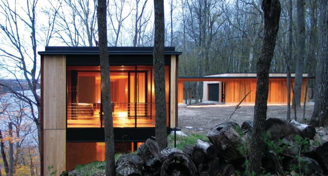 Camouflage House picks up the visual rhythm of its forested site.