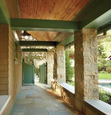 A hinged gate and limestone bench help define a side entryway to a home, turning it into a loggia that’s as welcoming as the front way in, with a gently sloped ramp that makes it wheelchair-accessible. Stone columns, painted trim, and a tongue tongue-and and-groove ceiling give this circulation space extra-special presence.


The New American Bungalow, Evanston, Ill. Architect: Cohen Hacker Architects, Evanston, Ill.; Builder: Sturm Builders, Northbrook, Ill.