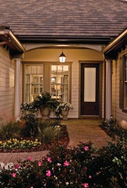 Sink In Permeable pavers in the driveway and front walk promote natural stormwater drainage. An opaque glass entry door by Therma-Tru provides privacy while allowing natural light to filter inside.