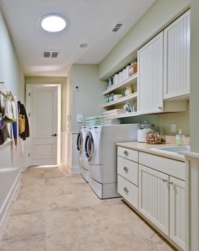 Chores to Adore A combination mudroom/laundry off the garage includes pretty beadboard cabinets by Merillat, a Shaker peg rail for coats and bags, and a large utility sink for hand-washing clothes, flower arranging, or pet bathing. A sun tunnel overhead brings in natural light without electricity.