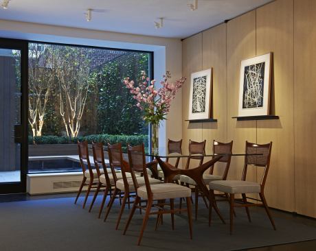 Moveable walls in the dining room conceal storage closets. On the doors are ledges for displaying art. 