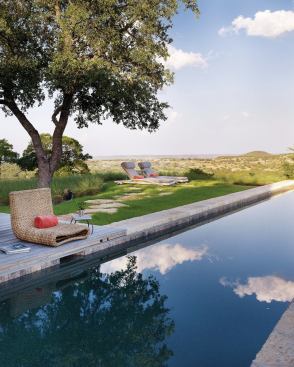 The structure is pulled back from the edge of the hill to create a feeling of floating in the landscape.
