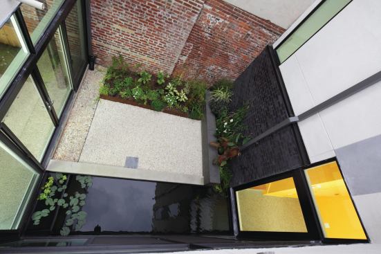 A central shade garden acts as a passive cooling element and a light well for the entire house.