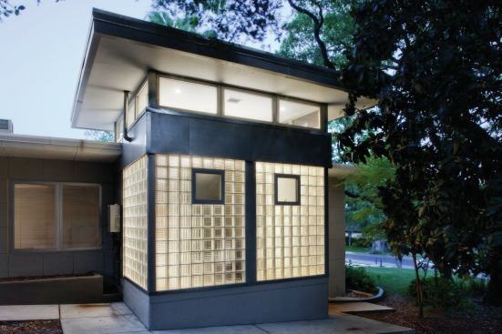 The glass walls of this bathroom are lifted straight from mid-century design, and they're made from off-the-shelf blocks. The wall looks striking from both inside and out, and it drenches the bathroom behind it in light while affording maximum policy. Four Palms, Austin, Texas. Architect/builder: CG&S Design/Build, Austin.
