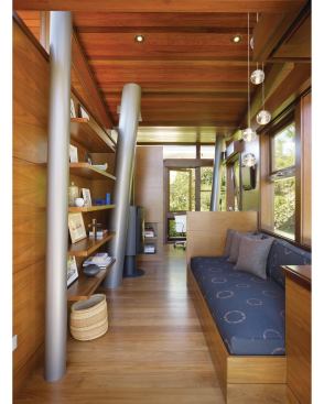 Cedar siding and mahogany floors recall a tree house kind of style, but in a more finished form. Hollow, canted columns serve as support beams for the structure. They’re also the pipes that supply the tree house with running water. 