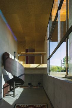 A sumptuously curving stairway serves as the studio's grand flourish.