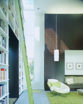 Kitchen and sleeping quarters step up to the library cube, where strategic glazing reduces glare while preserving views.