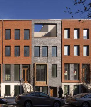 The architects skillfully played with shadows and sunlight on the project’s


street façade, emphasizing its deep window recesses, copper bays, and


top-floor cutouts. Variously colored sand-cast brick possesses a light-catching


texture.