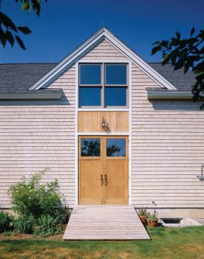 Twin barn doors provide access to indoor firewood storage.