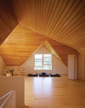 The barns second-floor studio was conceived as an open space for yoga and family gatherings. Its sloping, fir-paneled ceiling creates an almost ceremonial atmosphere.

