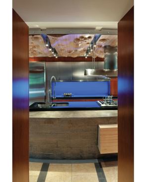 This clean, contemporary kitchen in Omaha features a mix of materials, including stainless steel, cast concrete, cherry, bubinga, and maple.  