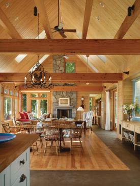 Reclaimed fir beams and local stone and wood finishes preserve the rustic charm and scale of the original cabin that this home replaced. Paneling, flooring, and siding were milled from trees removed from the site.