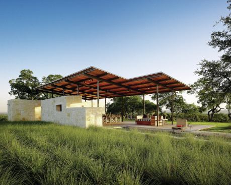 Native grasses tie the pavilion to its surroundings.
