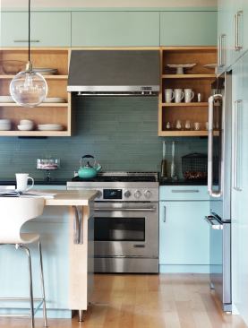 Honed black granite counters and a recycled glass backsplash complement locally made maple plywood cabinets.