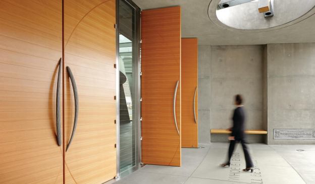 Entry doors with Vesica Piscis–inspired custom door pulls
