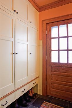 As part of an update to this 1900s Craftsman, the entryway was brought up to speed with modern life thanks to cabinetry that provides a hideaway for backpacks, sports equipment, and coats, while providing a subtle space for boots and shoes. Project: Craftsman Home, Minneapolis; Builder: Full Circle Construction, Minneapolis; Architect: Rehkamp Larson Architects, Minneapolis