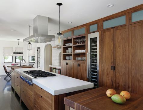 The kitchen is in a remodeled home, and the room's footprint was narrow. Designer TRG Architects specced a slim, 30-inch wide kitchen island with plenty of storage and a rolling worktable at one end.