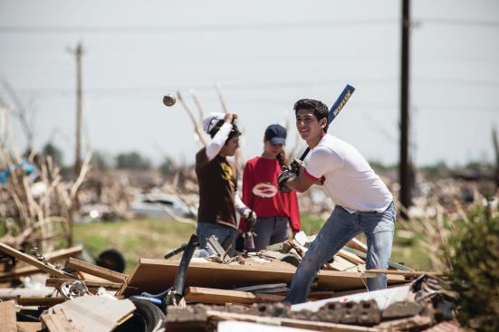 Volunteers take a much-needed break while clearing debris.