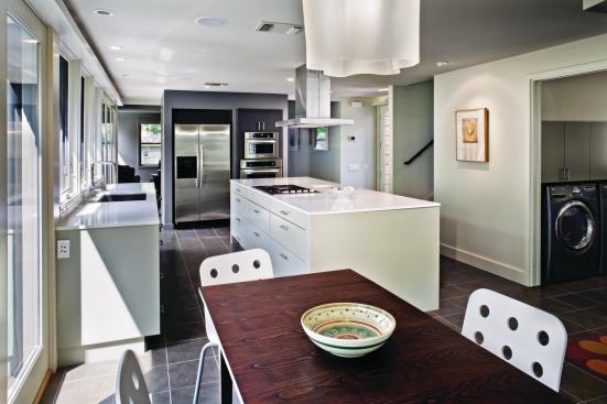 View from breakfast nook through the kitchen to dining and living spaces beyond.
