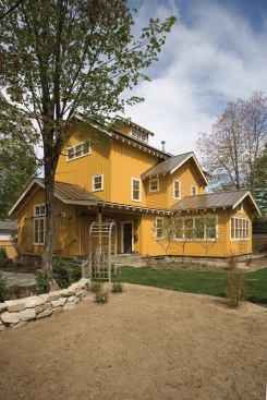 The 100% permeable lot features minimized turf area, drought-tolerant plants, and landscape stones recycled from the original deconstructed house.