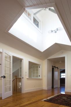 A cupola with operable windows helps natural light infiltrate the loft and the stairwell while promoting ventilation.