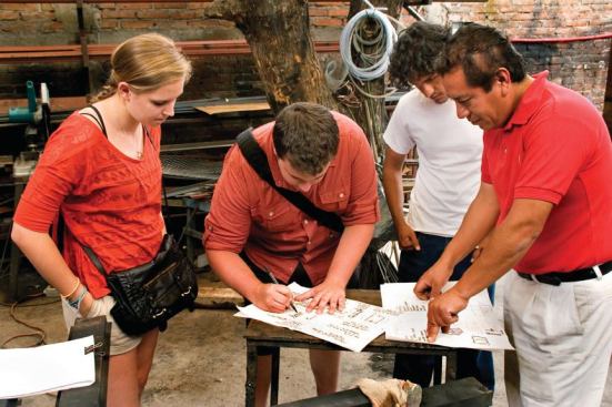 San Miguel blacksmith Gustavo Cano demonstrates welding and cutting techniques for fabricating the student-designed steel light fixtures.