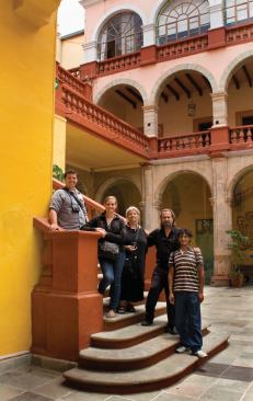 Cathi and Steven House pose with students on a field trip to the 1732 Hospice of the Holy Trinity, in Guanajuato.
