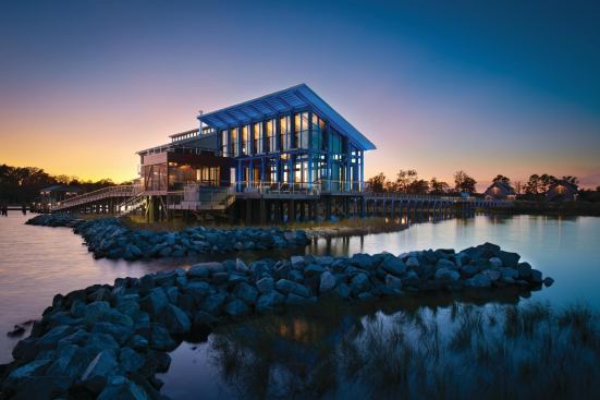 Expanses of hurricane-rated glass on the Chesapeake Bay side of the home allow dramatic water views for public spaces. Deep overhangs provide relief from the sun.