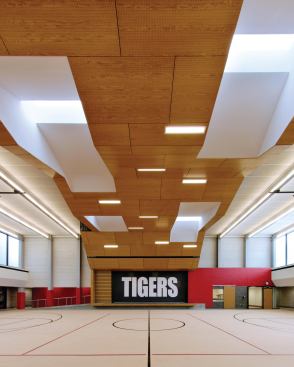 Gymnasium with insulated door lowered to acoustically isolate drama stage