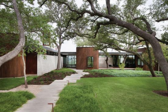 The lozenge-shaped, slatted element draws the focus away from the three-car garage—a big mass—and adds visual interest to the entire elevation.