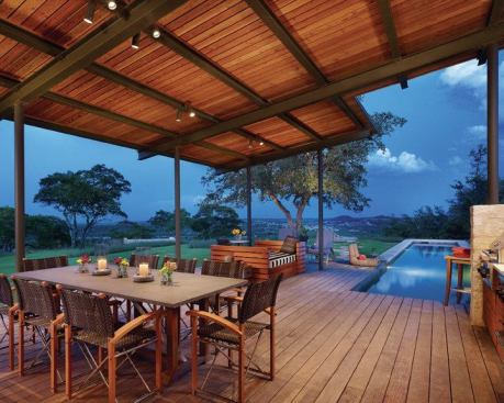 The materials—steel, FSC-certified ipe, and Texas limestone—echo those on the main house.