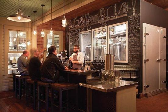 The sleek new bar has a view of the beer tanks. The original windows act as a pass-through to the kitchen addition.
