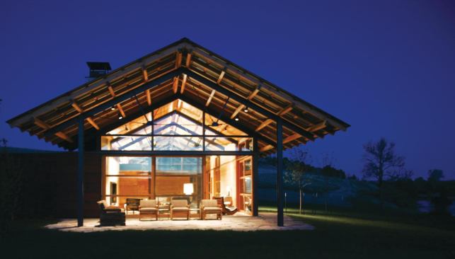 The main house includes a public zone with a pitched roof and a porch on either end.

