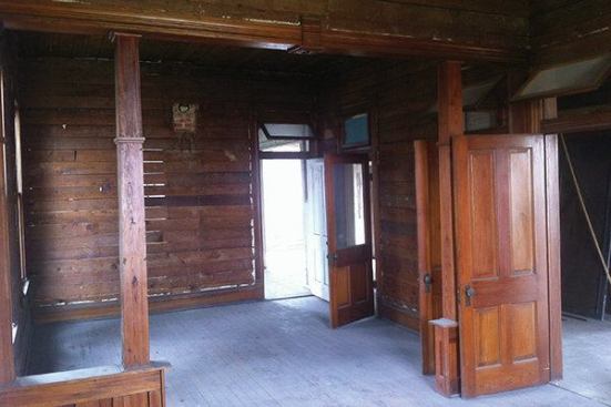The team was able to salvage the original pine walls and floors. The wall slats had been covered with a cheesecloth wallpaper.