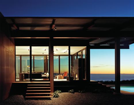 The living area connects to a garden and swimming pool.

