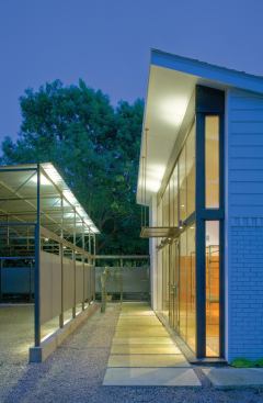Limestone pavers and a new gravel driveway leads from the front of the house to the carport and studio.

