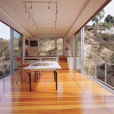 Sliding doors on either side let the owner open up her studio to the rugged natural environment.