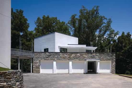 The bridge is tapered to tuck behind the reconstructed stone parapet on the south elevation.

