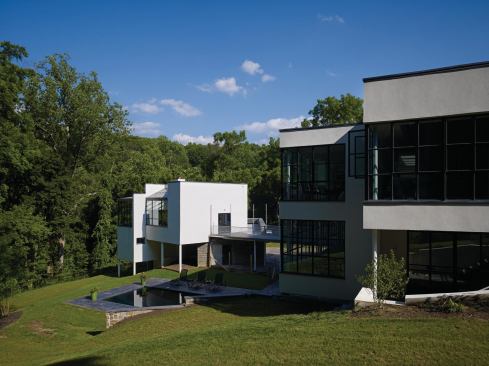 With its mid-20th-century appendages removed, the studios setting and massing are exposed. 

