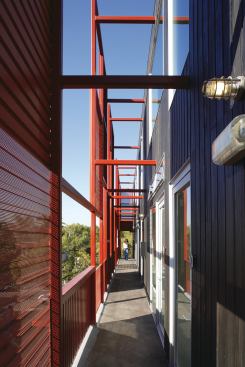 A series of screens along the exterior hallways serves to partially block the sun.


