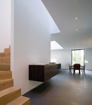 The ebony or zebra wood casework floats off the ground and "is thought of as a more animated element," architect David Jameson says. 

